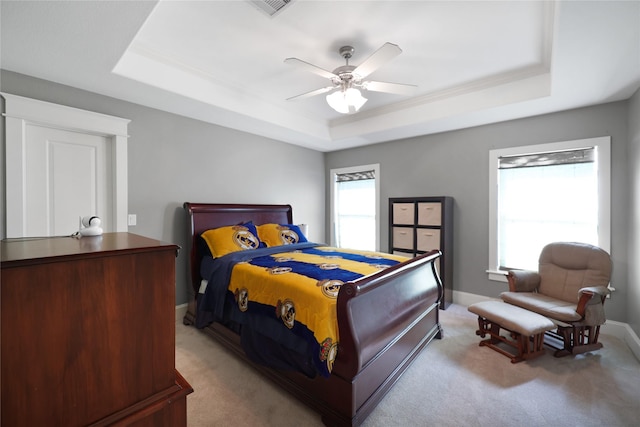 5523 Harvest Oak Landing Dr, Spring, TX 77386 - bedroom featuring a tray ceiling, light carpet, and ceiling fan