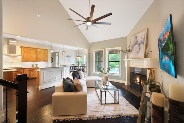 5523 Harvest Oak Landing Dr, Spring, TX 77386 - living area with high vaulted ceiling, a ceiling fan, a premium fireplace, and dark wood finished floors