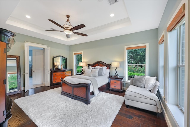 5523 Harvest Oak Landing Dr, Spring, TX 77386 - bedroom with a tray ceiling, multiple windows, dark wood-type flooring, and recessed lighting