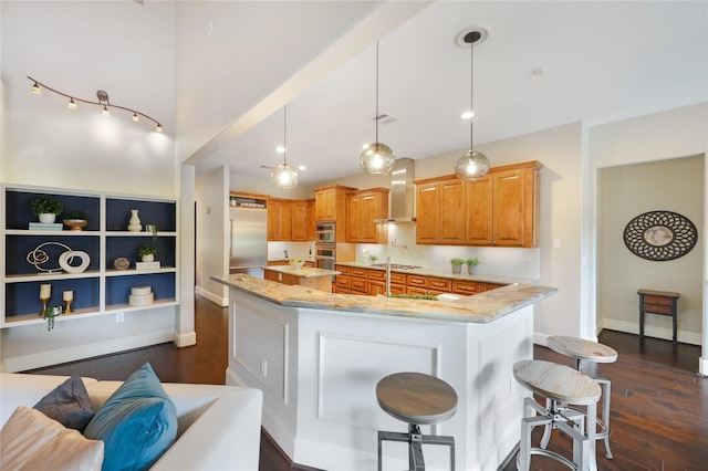 5523 Harvest Oak Landing Dr, Spring, TX 77386 - kitchen with wall chimney exhaust hood, a center island, dark wood-style flooring, light stone countertops, and a kitchen breakfast bar