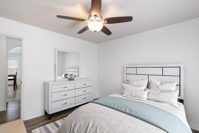 20930 Morgan Knoll Ln, Katy, TX 77449 - bedroom with arched walkways, dark wood-style floors, and a ceiling fan