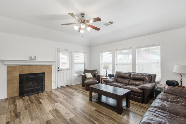 20930 Morgan Knoll Ln, Katy, TX 77449 - living room featuring a ceiling fan, wood finished floors, and a tile fireplace