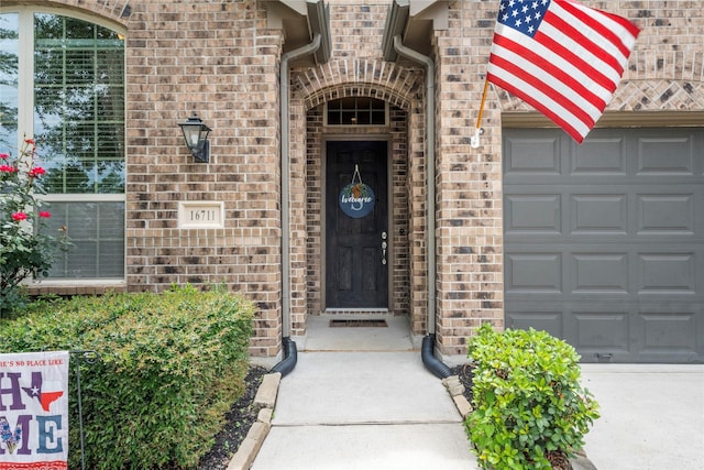 16711 Ramsay Cascades Dr, Humble, TX 77346 - entrance to property with an attached garage, brick siding, and driveway