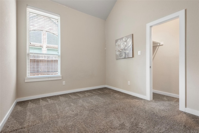 16711 Ramsay Cascades Dr, Humble, TX 77346 - unfurnished bedroom featuring carpet, lofted ceiling, and a spacious closet