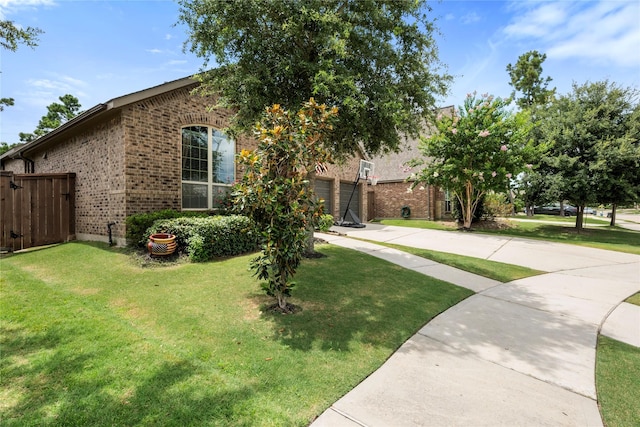 16711 Ramsay Cascades Dr, Humble, TX 77346 - view of front of property featuring brick siding, concrete driveway, and a gate