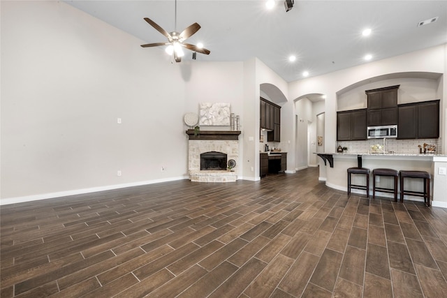 16711 Ramsay Cascades Dr, Humble, TX 77346 - living area with ceiling fan, recessed lighting, dark wood-style floors, and a fireplace