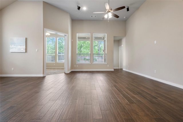 16711 Ramsay Cascades Dr, Humble, TX 77346 - unfurnished living room featuring a ceiling fan, dark wood-type flooring, and a high ceiling
