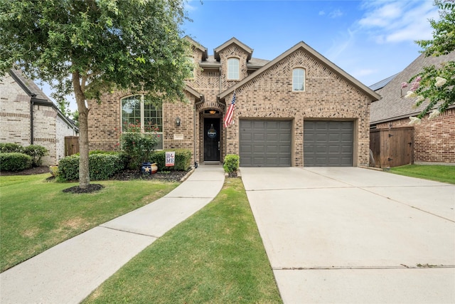 16711 Ramsay Cascades Dr, Humble, TX 77346 - view of front of home with brick siding, driveway, and an attached garage