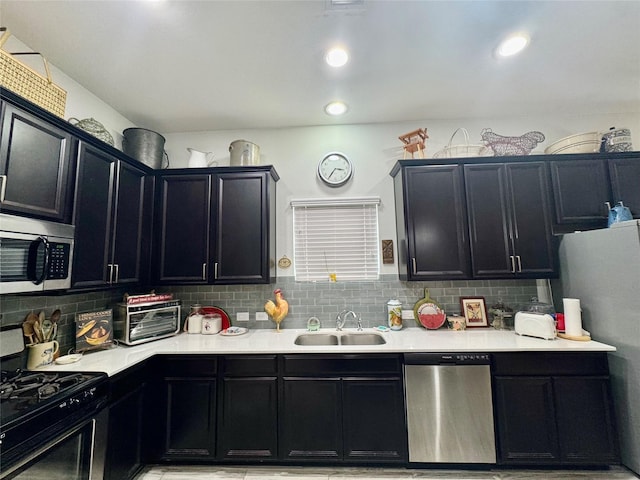 147 Castlegate Ln, Jersey Village, TX 77065 - kitchen featuring stainless steel appliances, dark cabinetry, light countertops, and backsplash
