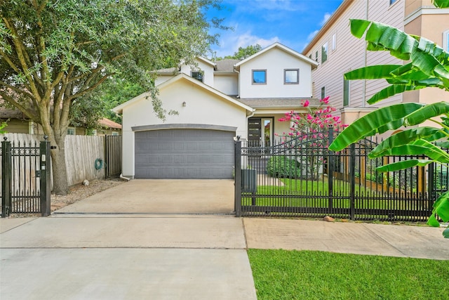 5204 Maxie St, Houston, TX 77007 - view of front of property featuring stucco siding, a garage, driveway, and a fenced front yard