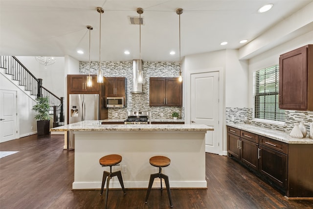 5204 Maxie St, Houston, TX 77007 - kitchen featuring tasteful backsplash, stainless steel appliances, a kitchen breakfast bar, a center island, and recessed lighting