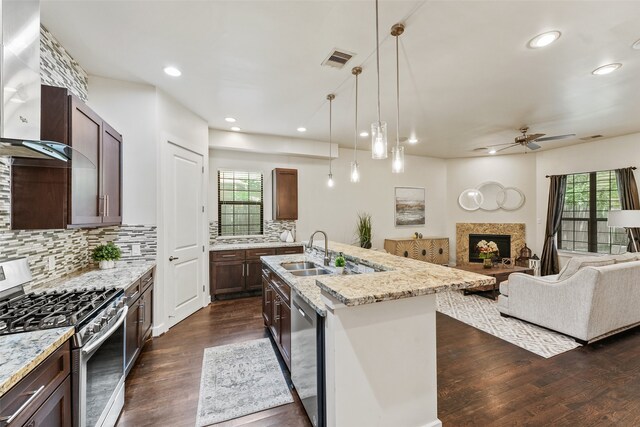 5204 Maxie St, Houston, TX 77007 - kitchen featuring appliances with stainless steel finishes, wall chimney exhaust hood, a ceiling fan, plenty of natural light, and recessed lighting