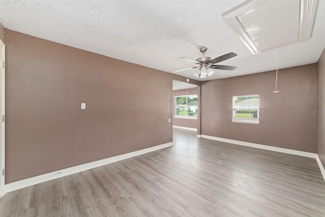 9333 Fairland Dr, Houston, TX 77051 - spare room with attic access, light wood finished floors, a textured ceiling, and a ceiling fan