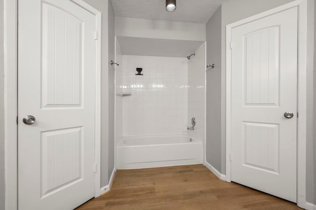 14902 Forest Lodge Dr, Houston, TX 77070 - bathroom with wood finished floors and bathing tub / shower combination