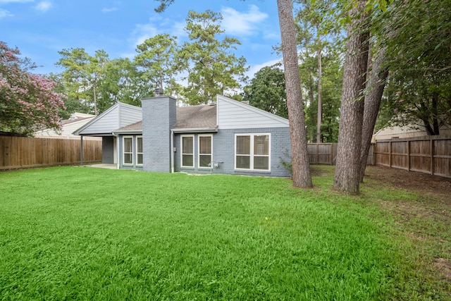 14902 Forest Lodge Dr, Houston, TX 77070 - back of property featuring a chimney, a fenced backyard, a shingled roof, and brick siding
