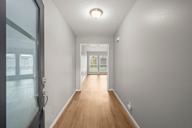 14902 Forest Lodge Dr, Houston, TX 77070 - corridor featuring light wood finished floors and a textured ceiling