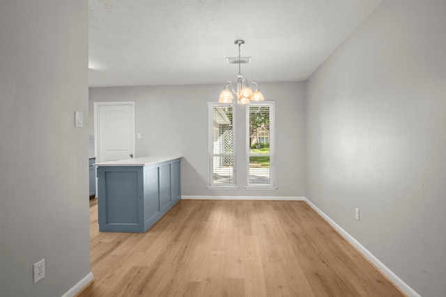 14902 Forest Lodge Dr, Houston, TX 77070 - unfurnished dining area featuring light wood-type flooring and a chandelier