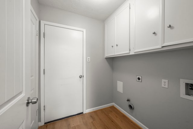14902 Forest Lodge Dr, Houston, TX 77070 - washroom featuring light wood finished floors, cabinet space, electric dryer hookup, hookup for a washing machine, and hookup for a gas dryer