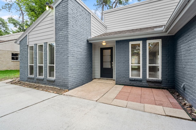 14902 Forest Lodge Dr, Houston, TX 77070 - view of exterior entry featuring a patio area and brick siding