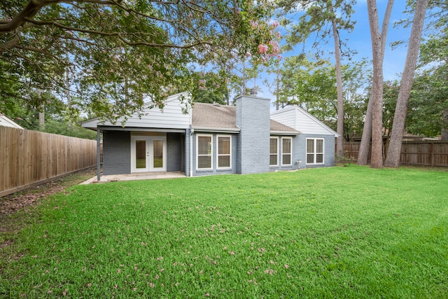 14902 Forest Lodge Dr, Houston, TX 77070 - rear view of property featuring french doors, brick siding, a chimney, a fenced backyard, and roof with shingles