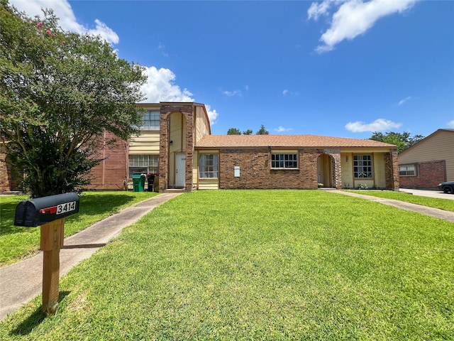 3412 Lantern Ln, Baytown, TX 77521 - view of front of property with a front lawn and brick siding