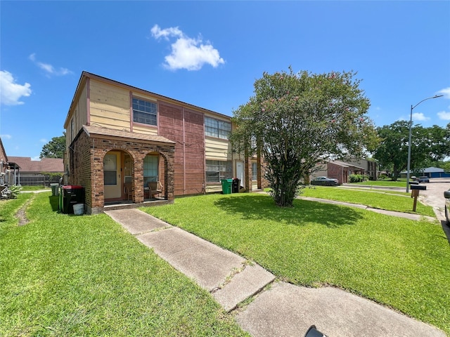 3412 Lantern Ln, Baytown, TX 77521 - view of property with a front yard, brick siding, and covered porch