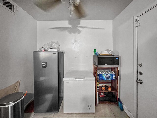 3412 Lantern Ln, Baytown, TX 77521 - washroom with ceiling fan and light tile patterned floors