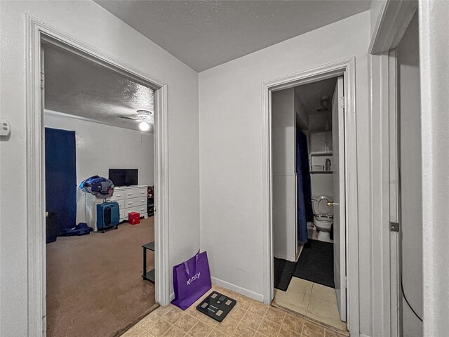 3412 Lantern Ln, Baytown, TX 77521 - hall featuring a textured ceiling and baseboards