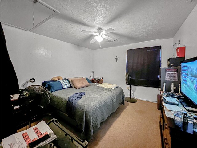 3412 Lantern Ln, Baytown, TX 77521 - carpeted bedroom featuring attic access, a textured ceiling, and a ceiling fan