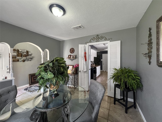 3412 Lantern Ln, Baytown, TX 77521 - dining area featuring light tile patterned flooring and a textured ceiling