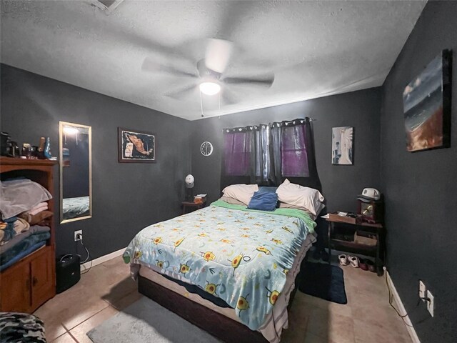3412 Lantern Ln, Baytown, TX 77521 - bedroom featuring a textured ceiling, a ceiling fan, and tile patterned flooring