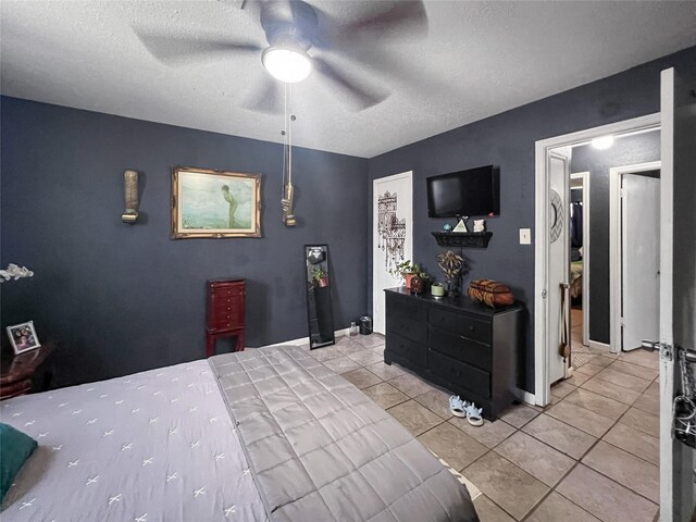 3412 Lantern Ln, Baytown, TX 77521 - bedroom featuring light tile patterned floors, a textured ceiling, and ceiling fan