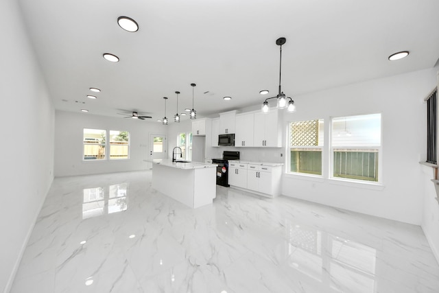 8023 Brandon St, Houston, TX 77051 - kitchen featuring black appliances, open floor plan, light marble finish flooring, white cabinetry, and recessed lighting