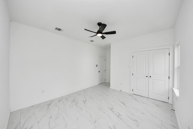 8023 Brandon St, Houston, TX 77051 - unfurnished bedroom featuring light marble finish floors, a closet, and a ceiling fan
