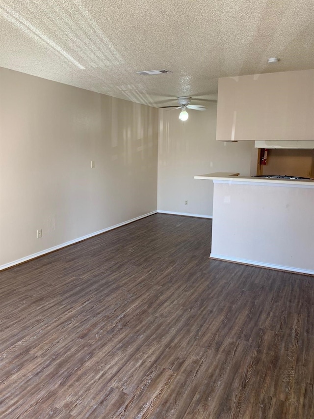 2501 Gulf Fwy Unit 246D, Dickinson, TX 77539 - unfurnished living room with dark wood-style flooring, a textured ceiling, and a ceiling fan