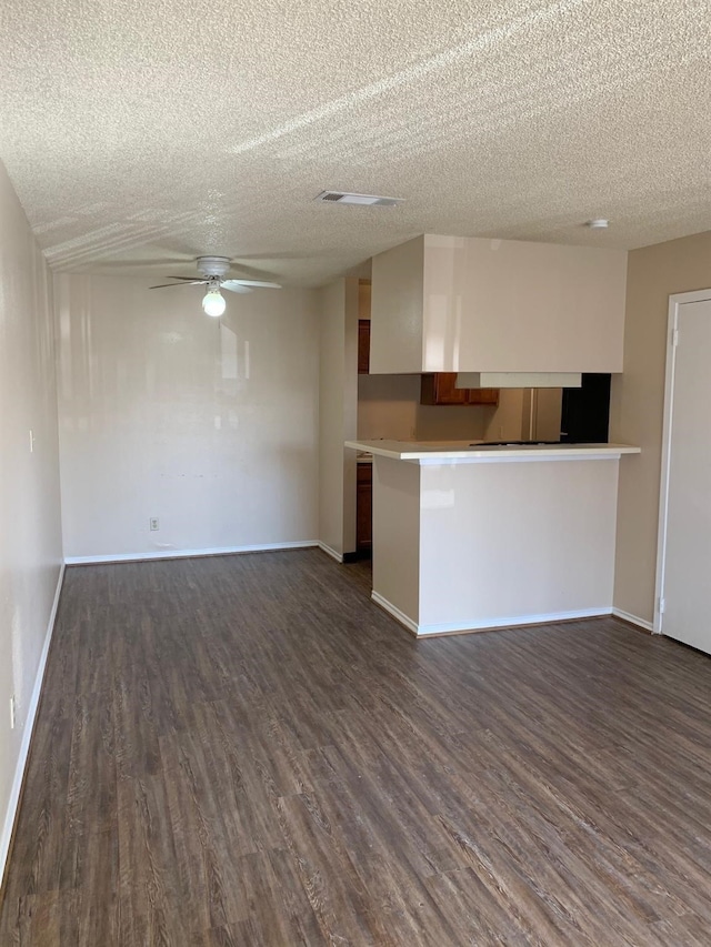 2501 Gulf Fwy Unit 246D, Dickinson, TX 77539 - kitchen with dark wood-style flooring, a ceiling fan, light countertops, a textured ceiling, and open floor plan