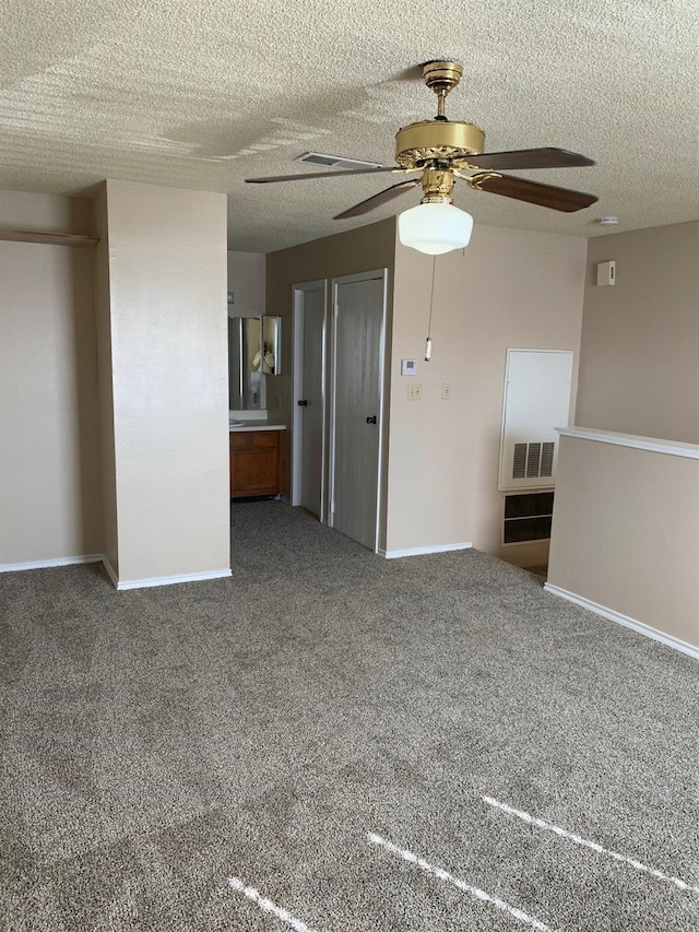 2501 Gulf Fwy Unit 246D, Dickinson, TX 77539 - unfurnished living room featuring ceiling fan, carpet flooring, and a textured ceiling