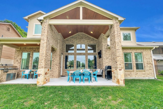 97 La Costa Dr, Montgomery, TX 77356 - rear view of house featuring brick siding, a patio area, an outdoor living space, and area for grilling