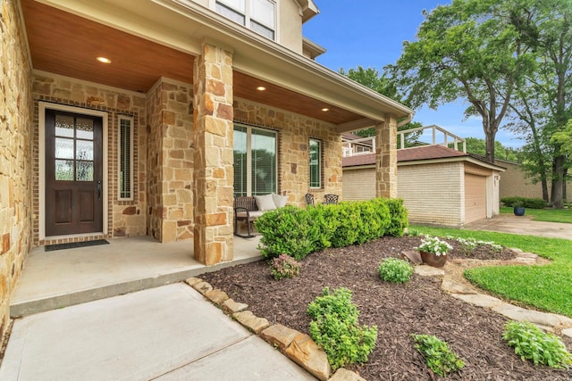 97 La Costa Dr, Montgomery, TX 77356 - property entrance featuring covered porch, stone siding, and a garage
