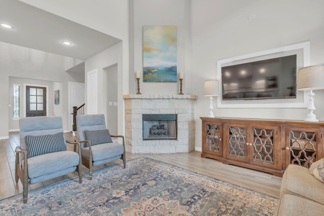 97 La Costa Dr, Montgomery, TX 77356 - living room with a stone fireplace, wood finished floors, recessed lighting, and stairway