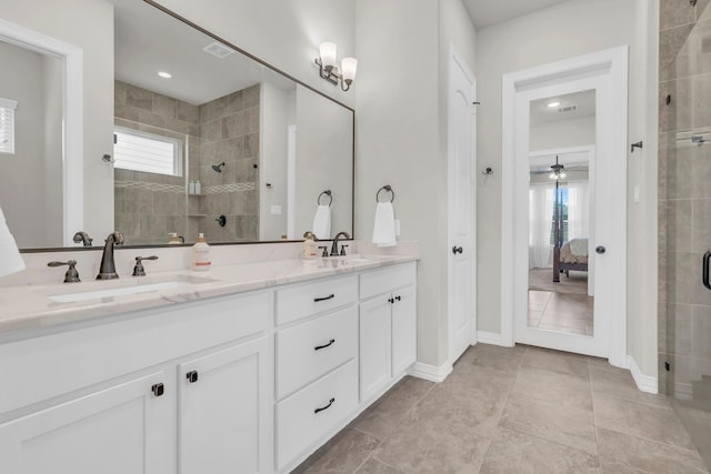 97 La Costa Dr, Montgomery, TX 77356 - full bathroom featuring double vanity, a tile shower, healthy amount of natural light, and tile patterned flooring