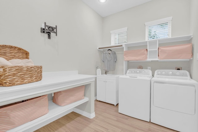 97 La Costa Dr, Montgomery, TX 77356 - laundry area with independent washer and dryer, cabinet space, and light wood finished floors