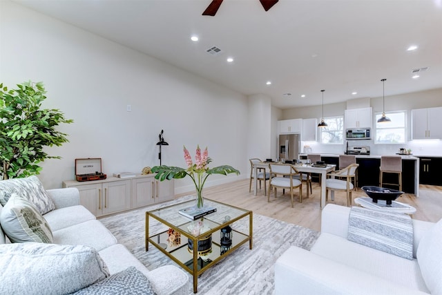 1306 Evelyn St, Houston, TX 77009 - living room featuring light wood-style floors, recessed lighting, and a ceiling fan