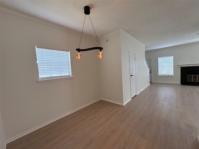 9850 Pagewood Ln Unit 909, Houston, TX 77042 - unfurnished dining area with wood finished floors, ornamental molding, and a fireplace with flush hearth
