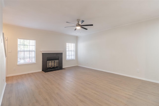 9850 Pagewood Ln Unit 909, Houston, TX 77042 - unfurnished living room featuring a ceiling fan, light wood-type flooring, a fireplace, and ornamental molding