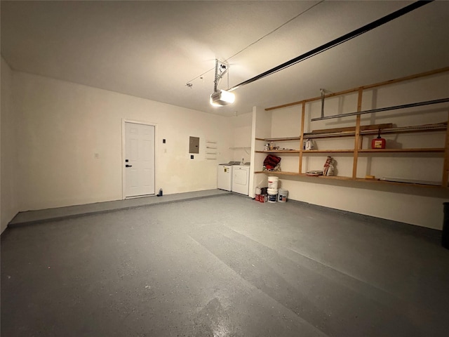 9850 Pagewood Ln Unit 909, Houston, TX 77042 - garage featuring washer and clothes dryer, electric panel, and a garage door opener