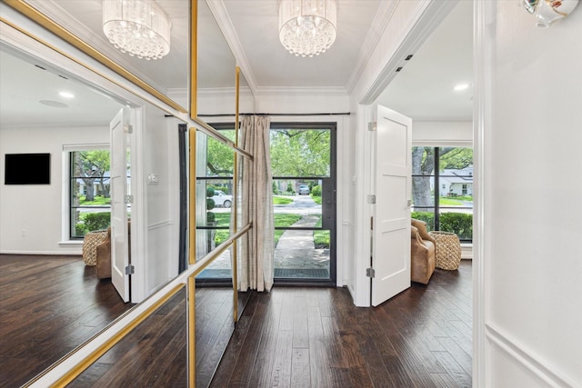 12118 Queensbury Ln, Houston, TX 77024 - foyer entrance featuring a chandelier, dark wood-type flooring, healthy amount of natural light, and crown molding