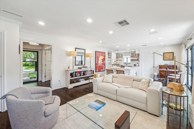 12118 Queensbury Ln, Houston, TX 77024 - living room featuring healthy amount of natural light, recessed lighting, light wood-style flooring, and crown molding