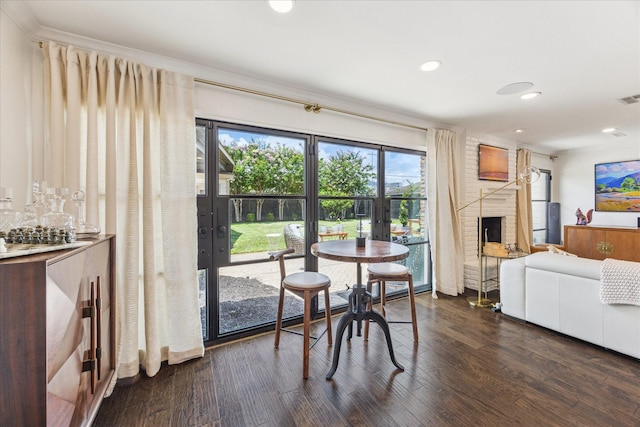 12118 Queensbury Ln, Houston, TX 77024 - dining area featuring french doors, dark wood finished floors, recessed lighting, a fireplace, and a bar