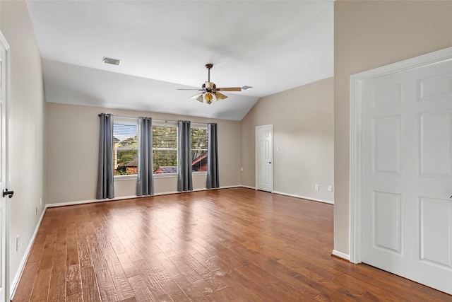7127 Vermejo Park Ln, Humble, TX 77346 - empty room featuring a ceiling fan, vaulted ceiling, and wood-type flooring